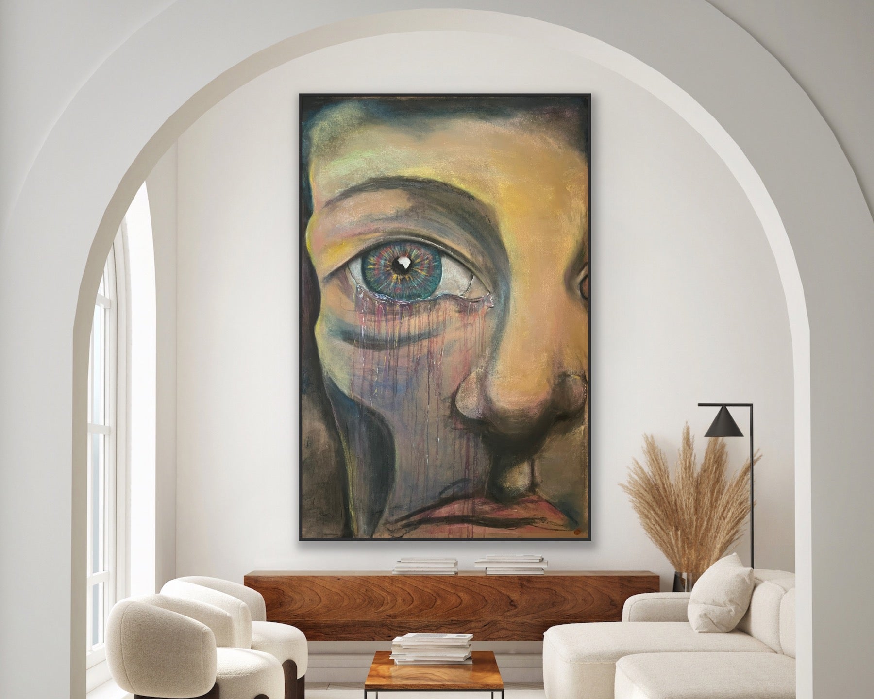 Modern living room with a large abstract painting of a face on the wall.